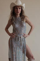 Sequin maxi top with high neckline and high slits paired with chain heart fringe belt and cowboy hat.
