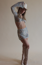Blue Twisted Top in Sequin Net and matching skirt paired with pearl belly chain and cowboy hat.