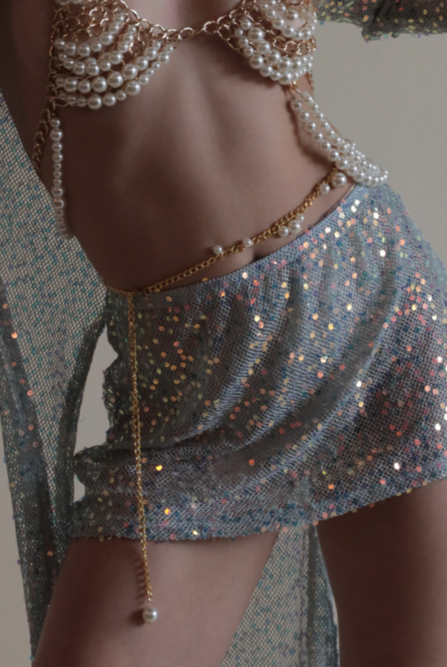 Gold and pearl belly chain paired with matching bra, mermaid sequin mini skirt, and mermaid sequin duster.