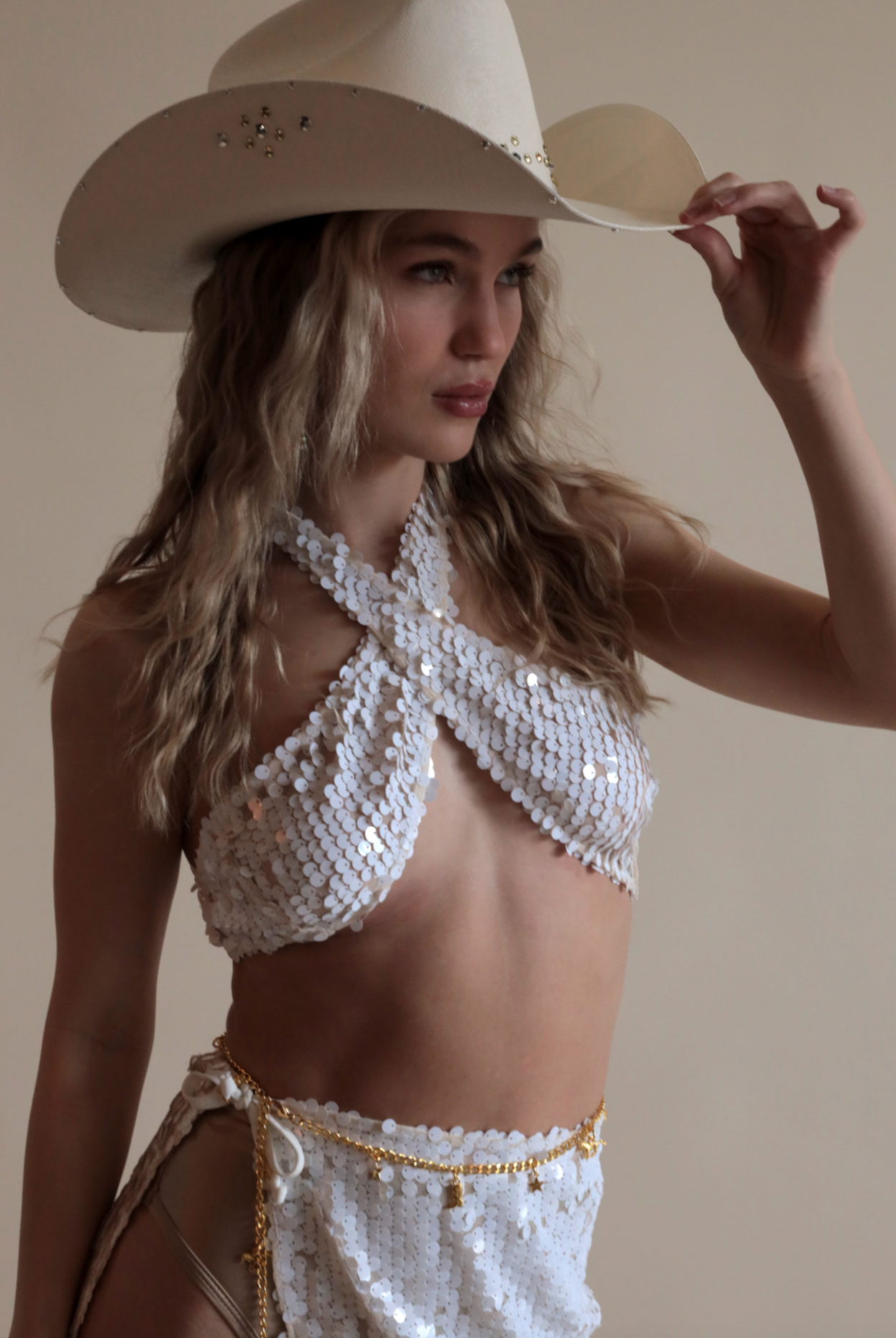 White Criss Cross Top in Mermaid Sequin with matching tie skirt and cowboy hat.