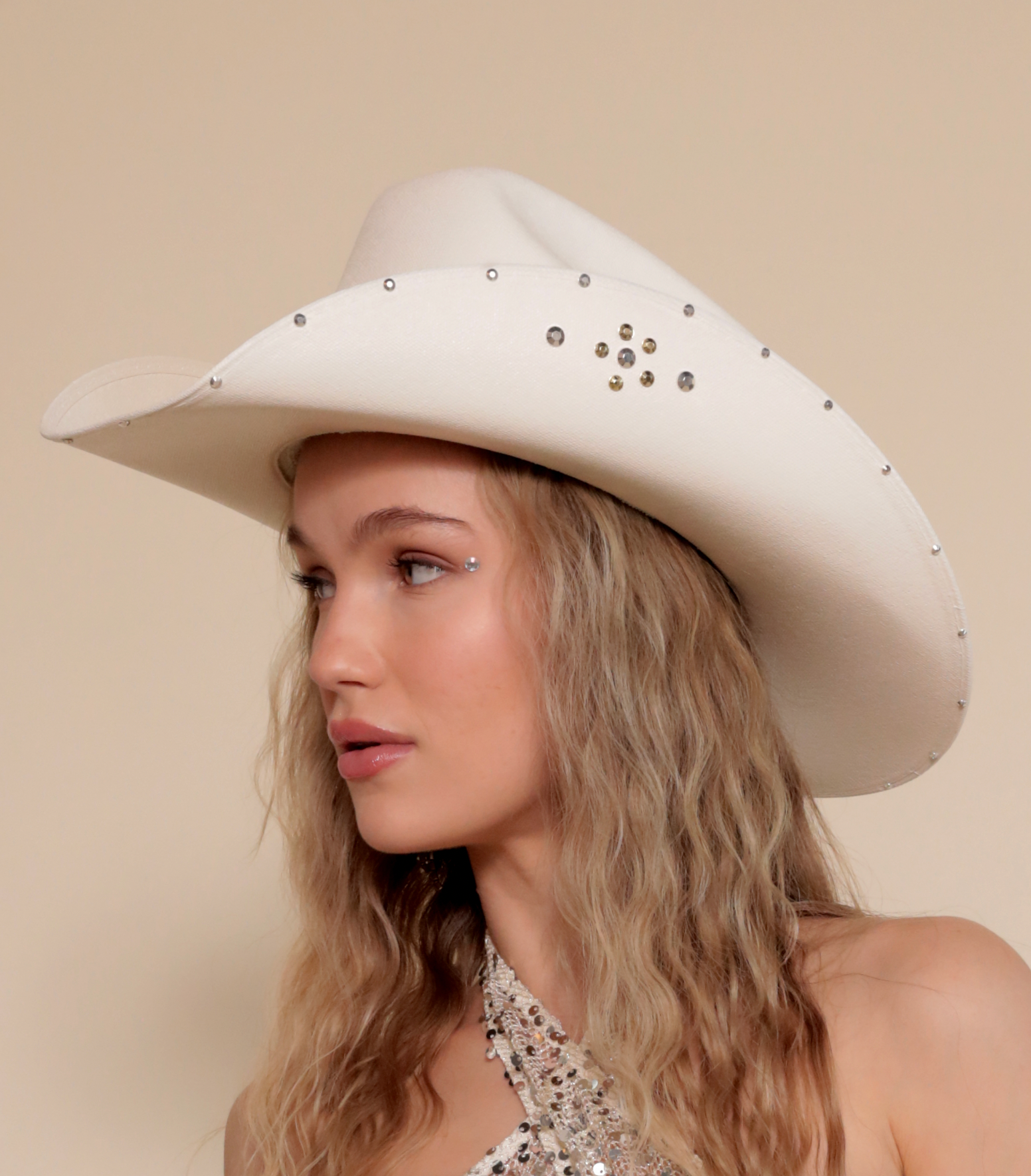 White cowboy hat with metallic jewels.