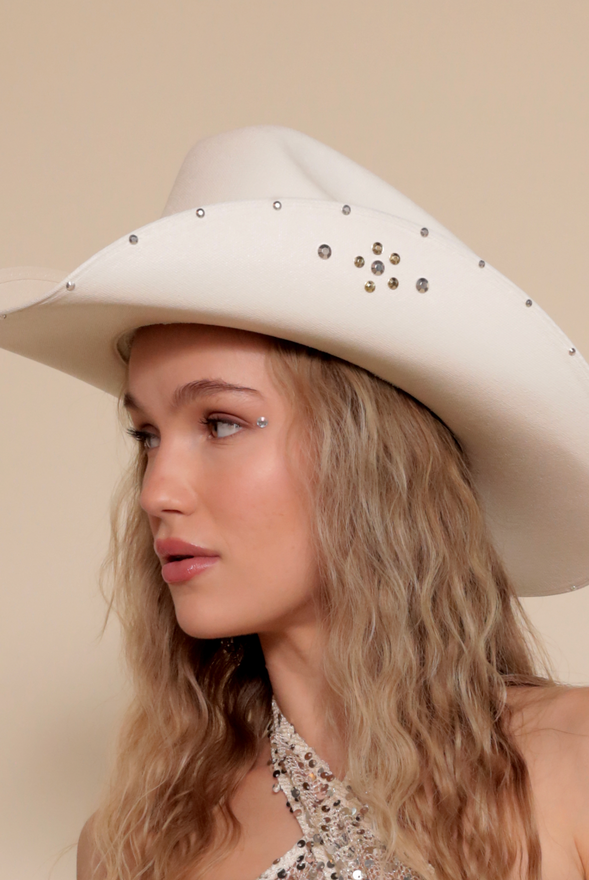 White cowboy hat with metallic jewels.