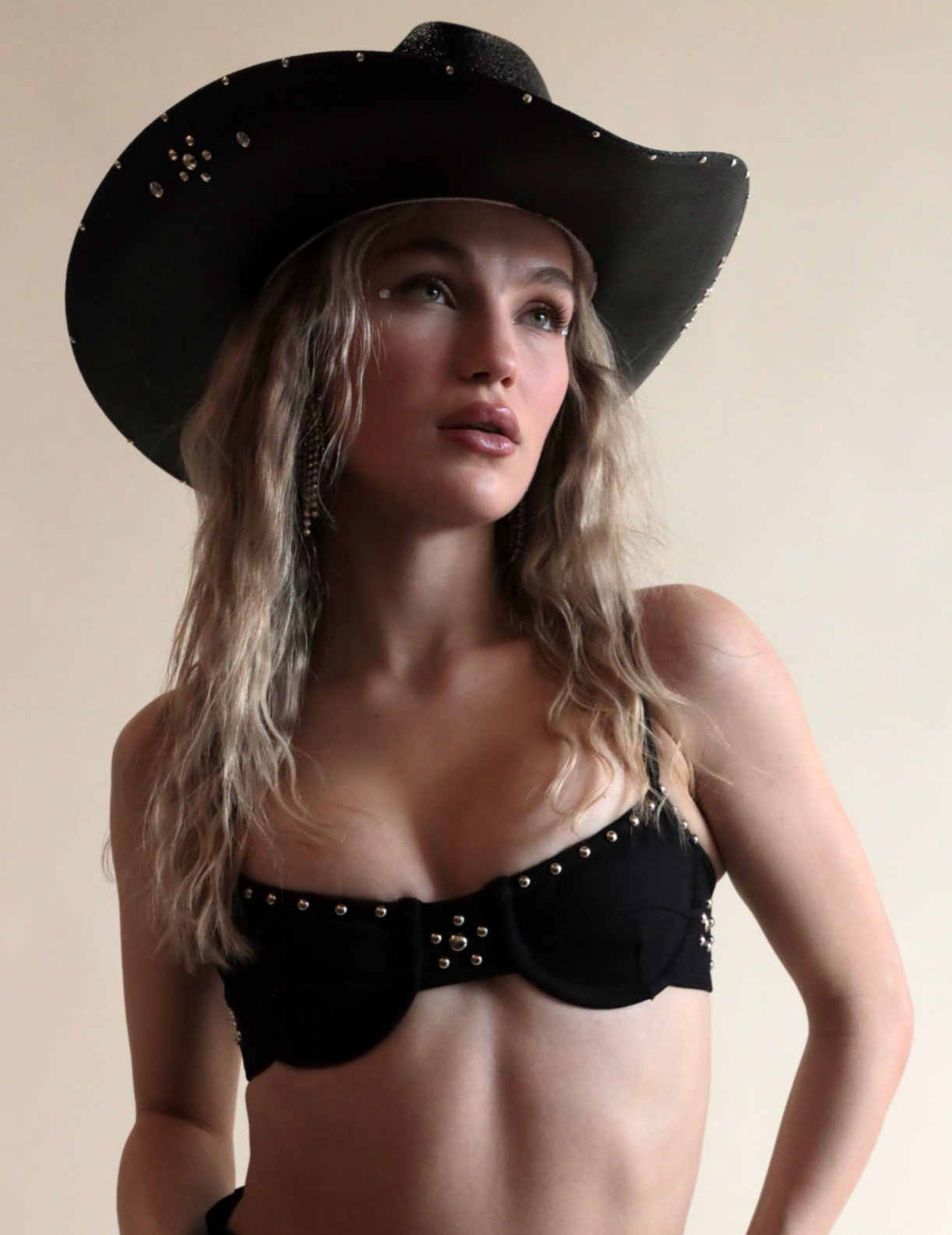 Black cowboy hat with metallic jewels paired with denim grommeted bra.