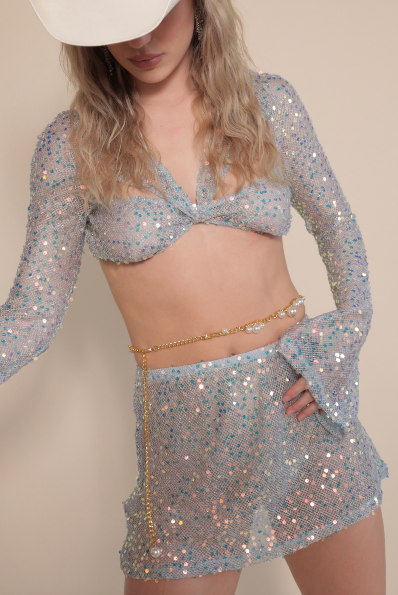 Blue Twisted Top in Sequin Net and matching mini skirt paired with pearl belly chain.